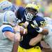 Michigan defensive tackle Ondre Pipkins is tied up by Air Force offensive lineman Jordan Eason during the second half at Michigan Stadium on Saturday. Melanie Maxwell I AnnArbor.com